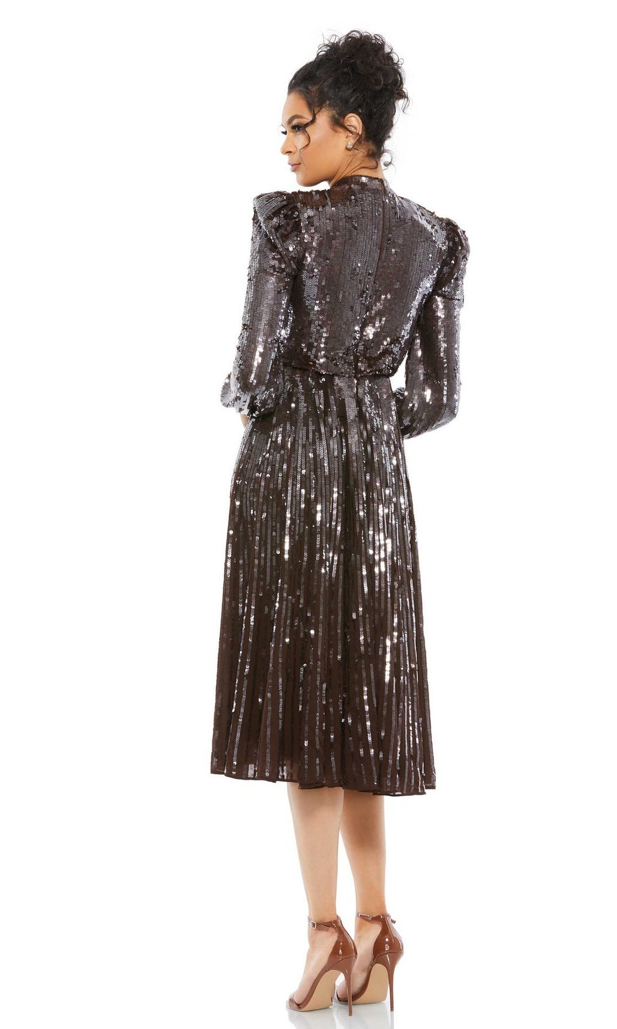 A woman faces away, wearing the Mac Duggal 93642 Brown Midi Wedding Guest Dress with sequins, long sleeves, a pleated skirt, and nude heels against a white background.